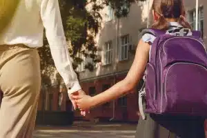 Mother taking child back to school following rehab